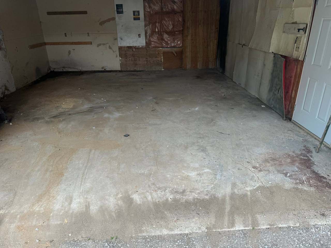 A garage completely emptied and swept after a full junk cleanout