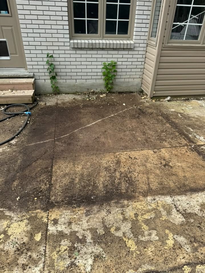 The bare concrete pad beside the house after the hot tub, skirting and steps were hauled away