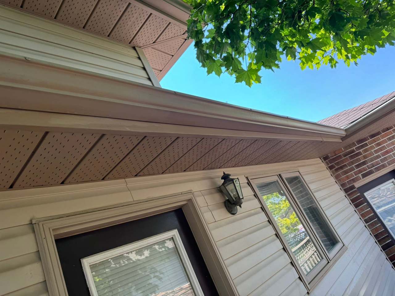 Soffit, eaves and siding washed clean of dirt streaks and green growth