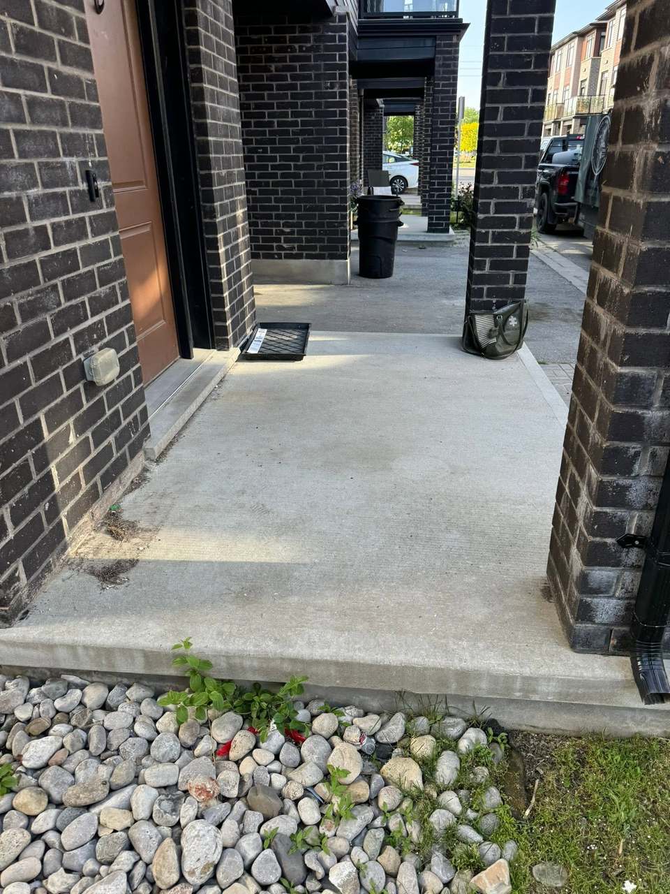 A back porch cleared of furniture, bags and old railings, left clean and empty